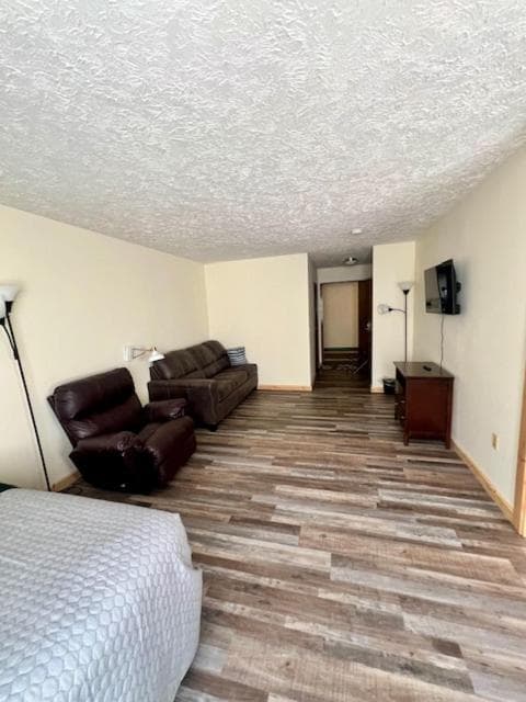 Living area of the newly renovated King Kitchenette Suite, with lounge seating and a TV